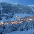 Aprica near Milan covered in snow with orange lights from the city near the ski slopes